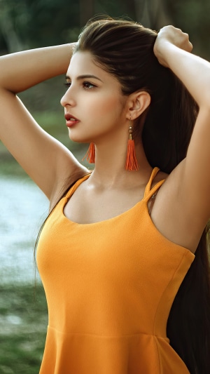Woman with orange dress and earrings