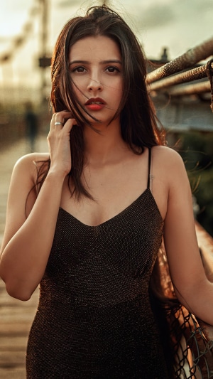 Woman in black dress on a bridge