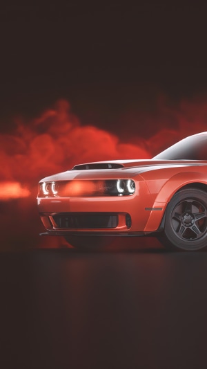 Orange Dodge Challenger with red smoke