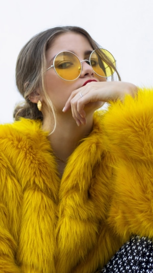 Sofia Reyes wearing yellow fur coat and sunglasses