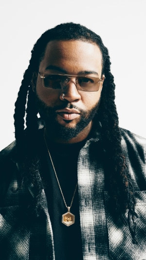 PartyNextDoor wearing sunglasses and a plaid shirt