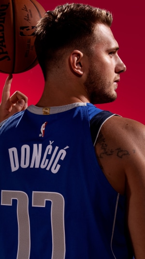 Luka Doncic wearing Dallas Mavericks jersey with basketball