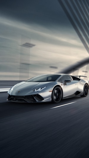 Silver Lamborghini Huracan driving on a road