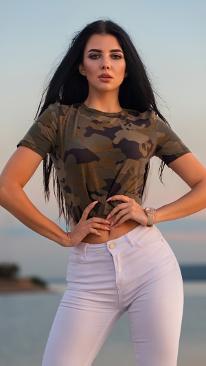Woman in camouflage t-shirt and white jeans