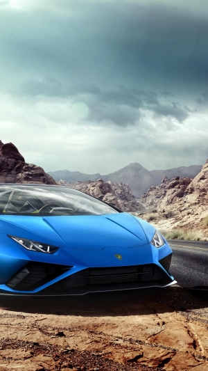 Blue Lamborghini Huracan Evo Spyder in desert mountains