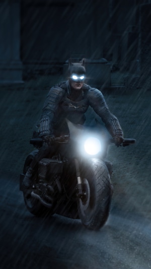 Batman on a motorcycle in the rain