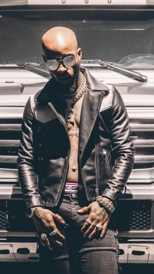 Tory Lanez wearing a leather jacket and jewelry
