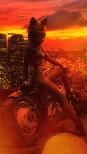 Biker in cat helmet on motorcycle overlooking city at sunset