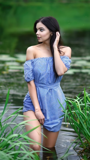 Model in a blue striped dress in water