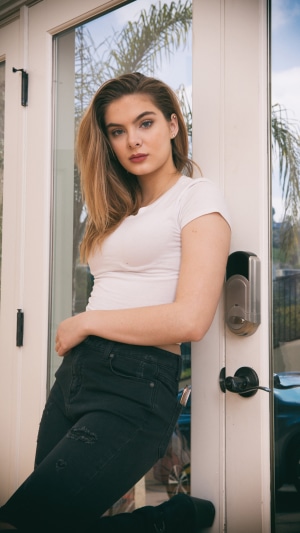 Brighton Sharbino in white top and black jeans