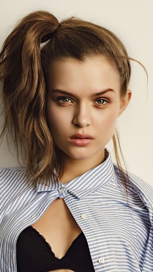 Josephine Skriver in a blue and white striped shirt