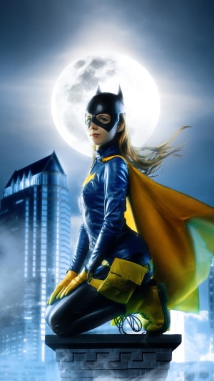 Batgirl cosplay on a rooftop at night