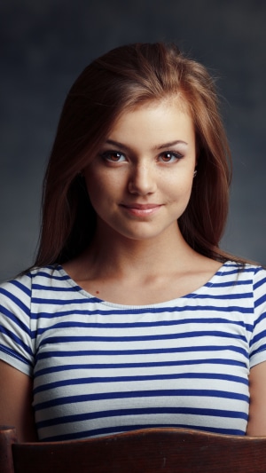 Young woman with brown hair wearing a striped shirt
