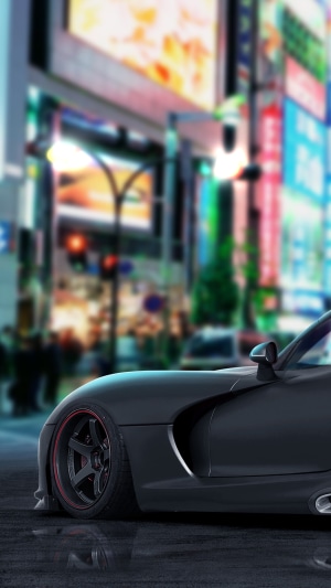 Black sports car in a neon-lit city street