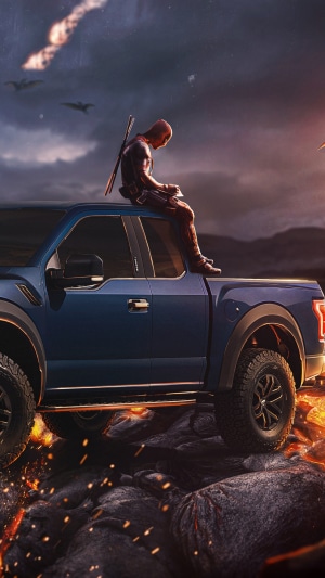 Deadpool sitting on a blue Ford Raptor truck