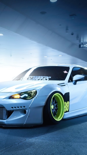 White Subaru BRZ with custom widebody kit and neon wheels