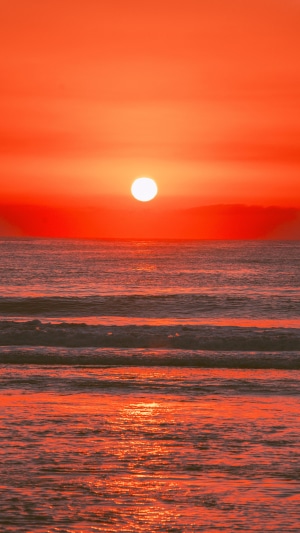 Ocean sunrise with sun over the water