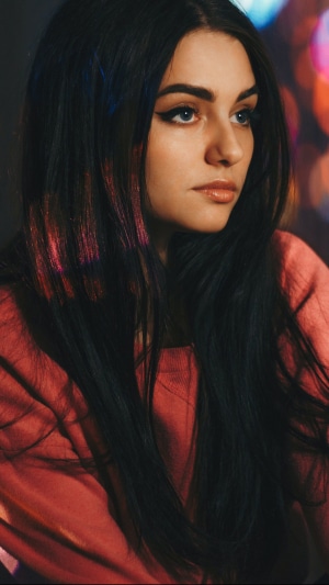 Model with dark hair and pink top