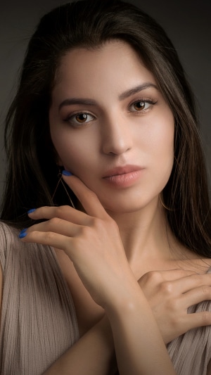 Model with dark hair and blue nails