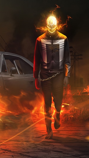 Ghost Rider walking through fire next to a car