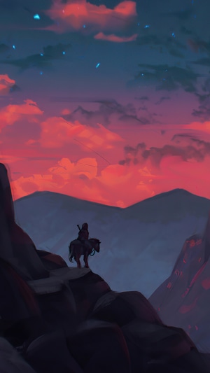 Person on horse overlooking mountains at sunset