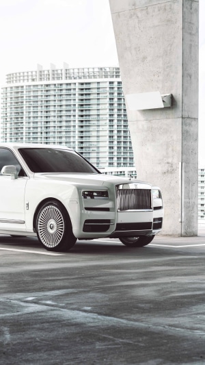 White Rolls-Royce Cullinan parked near a building