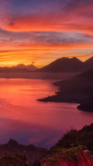 Sunrise over a lake with mountains