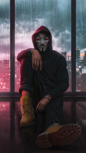 Anonymous hacker in a hoodie with red eyes