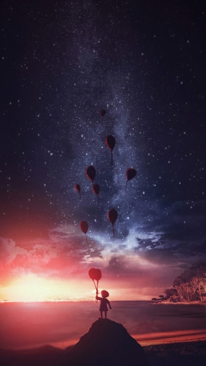 Child holding balloons under starry sky