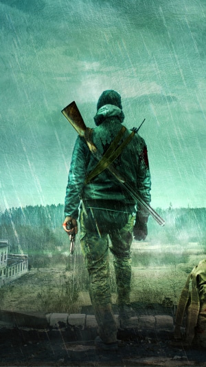 Man with rifle and pistol in the rain