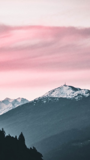 Snow-capped mountains under pink sky