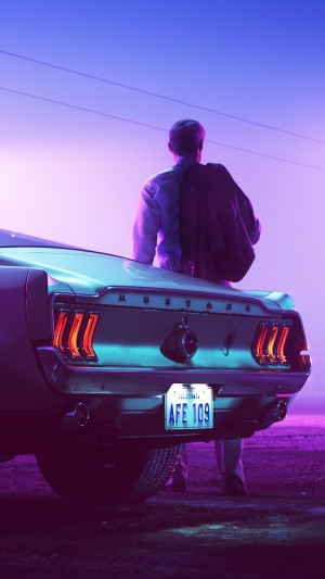 Man with jacket and Ford Mustang at dusk