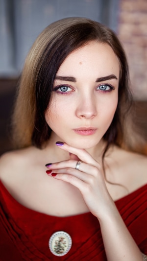 Young woman with blue eyes and red dress