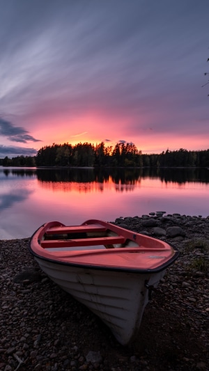 Boat on a rocky shore during sunset