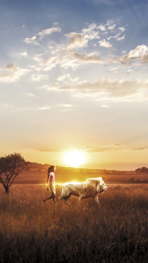 Girl and Lion in a Field at Sunset