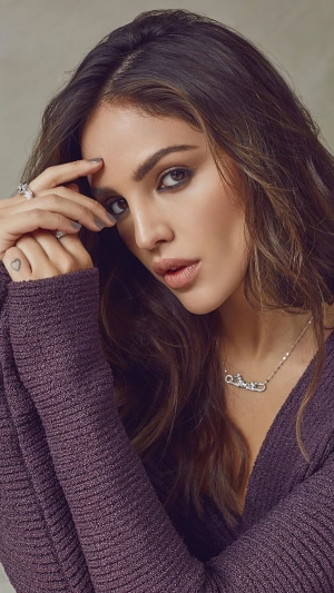Eiza Gonzalez wearing a purple sweater and necklace