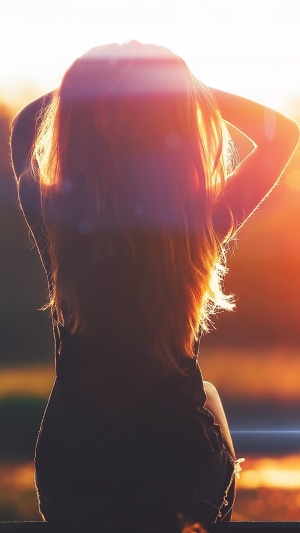 Girl with long hair at sunset