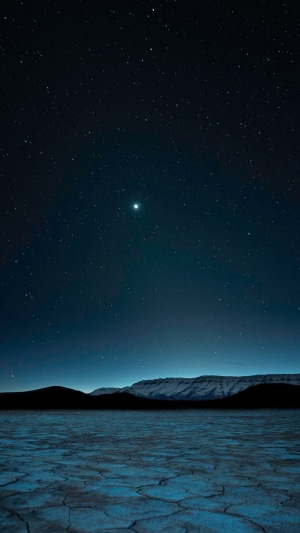 Desert landscape under starry night sky 4K