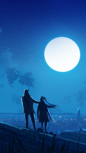 Couple looking at the moon over a city