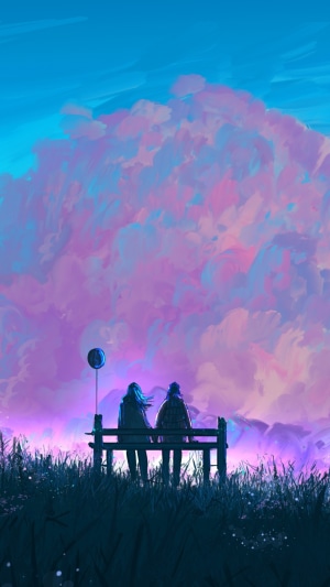 Couple sitting on a bench with a balloon
