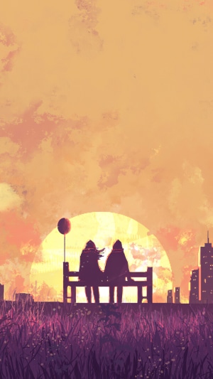 Couple sitting on a bench with a balloon at sunset