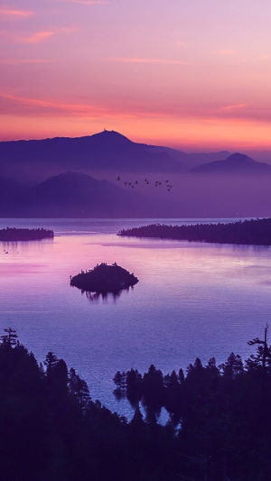 Digital art of a lake and mountains at sunset