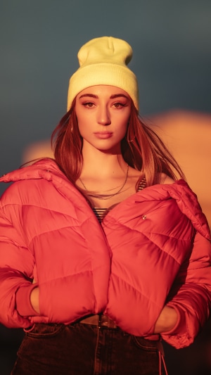 Girl in a red puffer jacket and yellow beanie