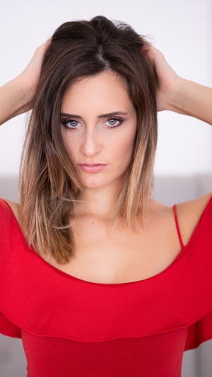 Model in a red dress with hands in hair
