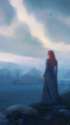 Woman looking at mountains and lake