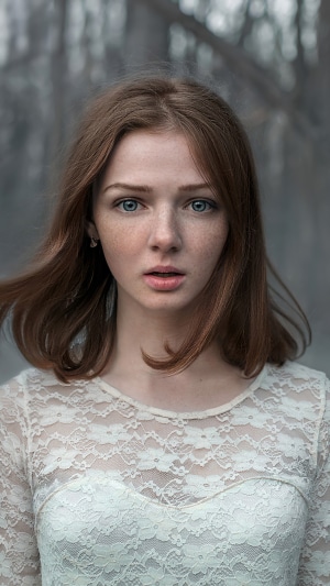Young woman with freckles and blue eyes
