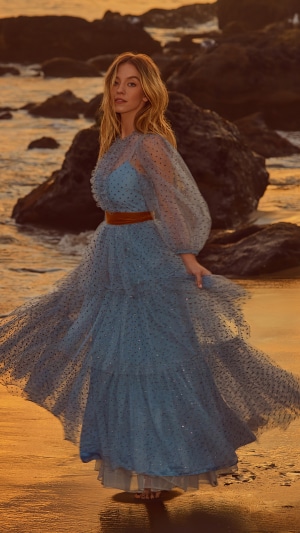Sydney Sweeney in a blue polka dot dress on the beach