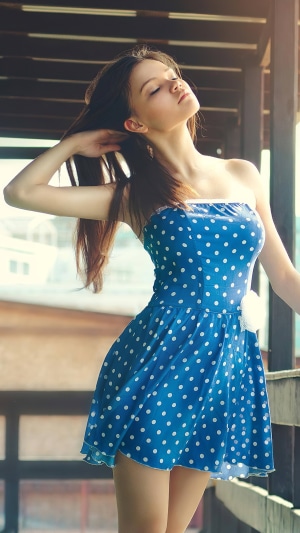 Girl in blue polka dot dress