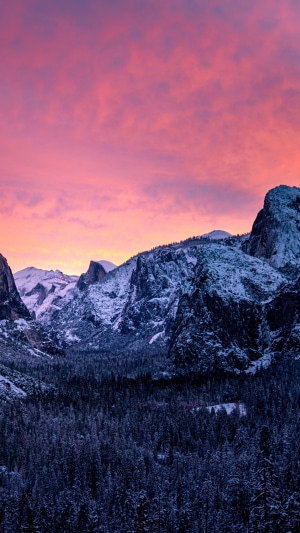 Snowy mountains and forest at sunset in Yosemite