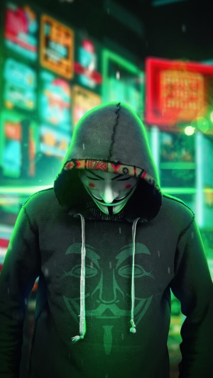 Anonymous hacker in a hoodie with a mask